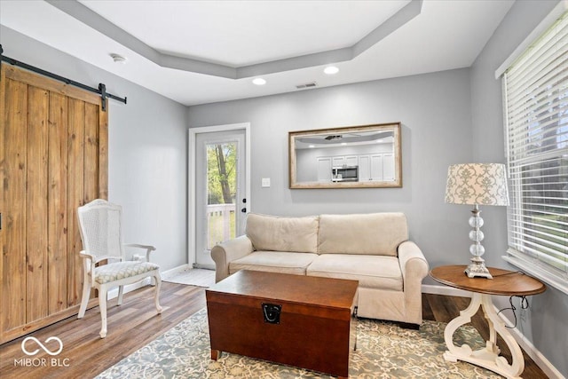744 Gilbert Ave, Indianapolis, IN 46227 - living area featuring wood finished floors, a barn door, baseboards, recessed lighting, and a raised ceiling