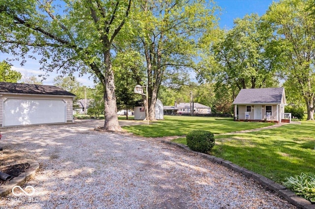 744 Gilbert Ave, Indianapolis, IN 46227 - view of grassy yard with an outbuilding and a garage