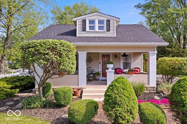 744 Gilbert Ave, Indianapolis, IN 46227 - view of front of home featuring a porch, roof with shingles, and brick siding