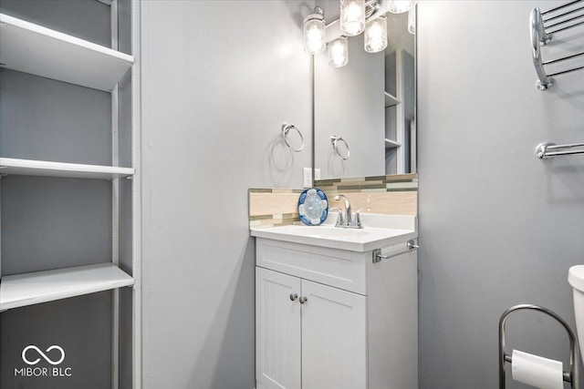 744 Gilbert Ave, Indianapolis, IN 46227 - bathroom featuring decorative backsplash, vanity, and toilet