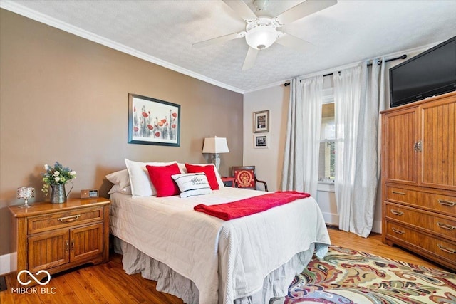 744 Gilbert Ave, Indianapolis, IN 46227 - bedroom featuring light wood finished floors, ornamental molding, and ceiling fan