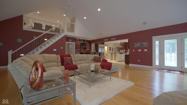 4363 E State Road 252, Franklin, IN 46131 - living room featuring high vaulted ceiling, stairs, ceiling fan, light wood-style floors, and baseboards