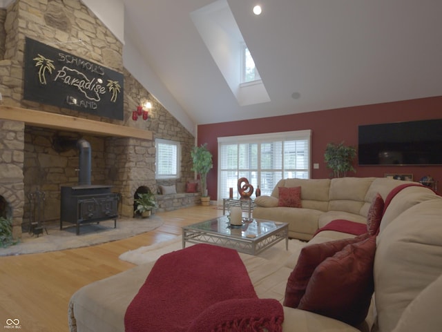 4363 E State Road 252, Franklin, IN 46131 - living room featuring high vaulted ceiling, a wood stove, a skylight, and wood finished floors