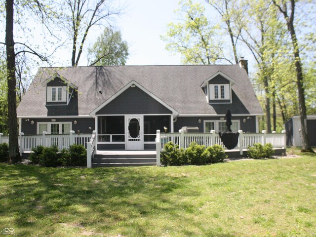 4363 E State Road 252, Franklin, IN 46131 - back of property featuring a sunroom, a deck, a chimney, and a lawn