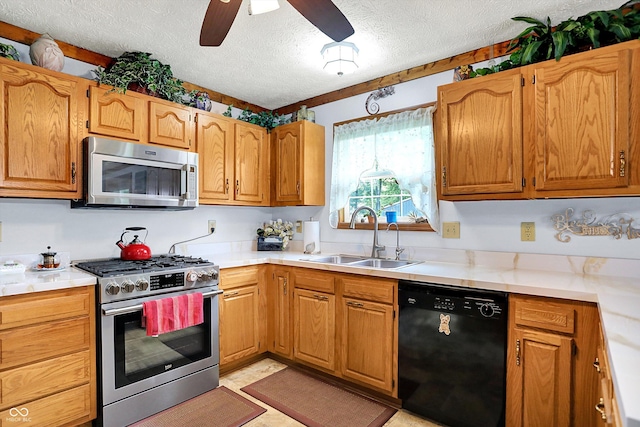 7655 N Kitchen Rd, Mooresville, IN 46158 - kitchen featuring appliances with stainless steel finishes, a sink, a textured ceiling, light countertops, and ceiling fan