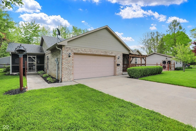 7655 N Kitchen Rd, Mooresville, IN 46158 - single story home with brick siding, a garage, concrete driveway, a front lawn, and a sunroom