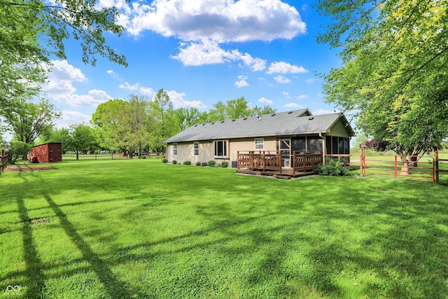 7655 N Kitchen Rd, Mooresville, IN 46158 - back of house featuring a sunroom, a storage shed, an outbuilding, and a deck