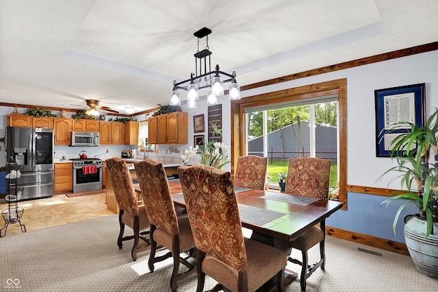 7655 N Kitchen Rd, Mooresville, IN 46158 - dining room featuring a raised ceiling, light carpet, baseboards, and ceiling fan