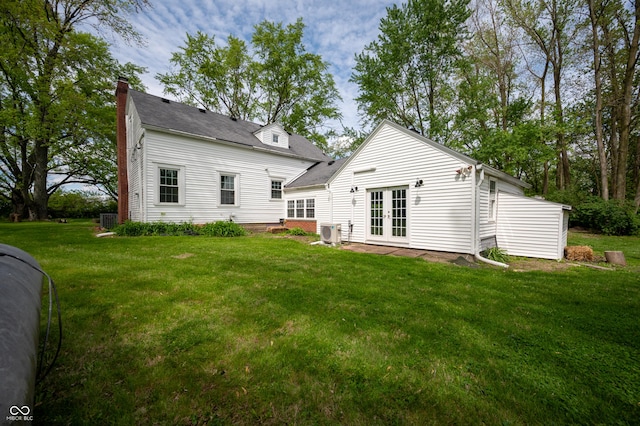 6851 W County Road 550 S, Daleville, IN 47334 - back of property featuring french doors, a yard, central AC, and a chimney