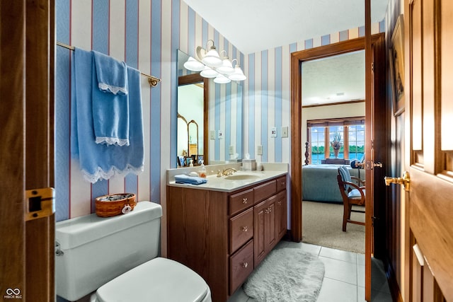 3107 Waterfront Cir, Anderson, IN 46012 - ensuite bathroom featuring wallpapered walls, toilet, vanity, and tile patterned flooring