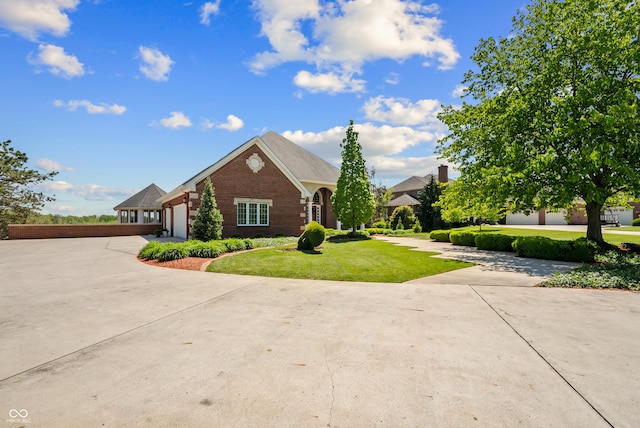 3107 Waterfront Cir, Anderson, IN 46012 - view of front of house with driveway, brick siding, a front lawn, and an attached garage