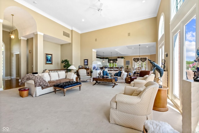 3107 Waterfront Cir, Anderson, IN 46012 - carpeted living area with a towering ceiling and crown molding