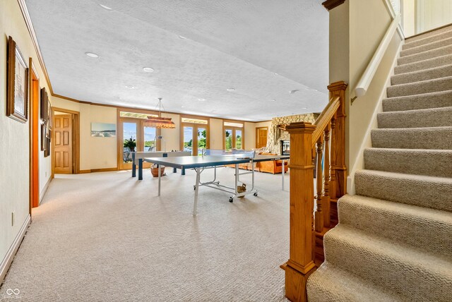 3107 Waterfront Cir, Anderson, IN 46012 - rec room featuring light carpet, baseboards, a textured ceiling, recessed lighting, and french doors