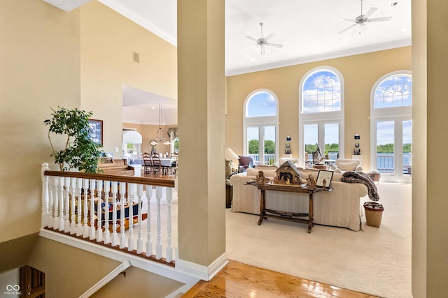 3107 Waterfront Cir, Anderson, IN 46012 - hallway with a towering ceiling, ornamental molding, wood finished floors, and baseboards