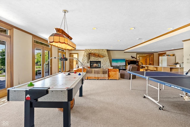 3107 Waterfront Cir, Anderson, IN 46012 - playroom with carpet flooring, crown molding, a stone fireplace, recessed lighting, and a textured ceiling