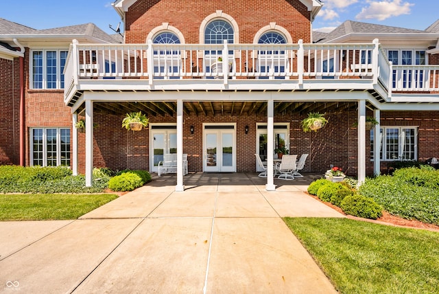 3107 Waterfront Cir, Anderson, IN 46012 - rear view of house featuring french doors, brick siding, a deck, and a patio area