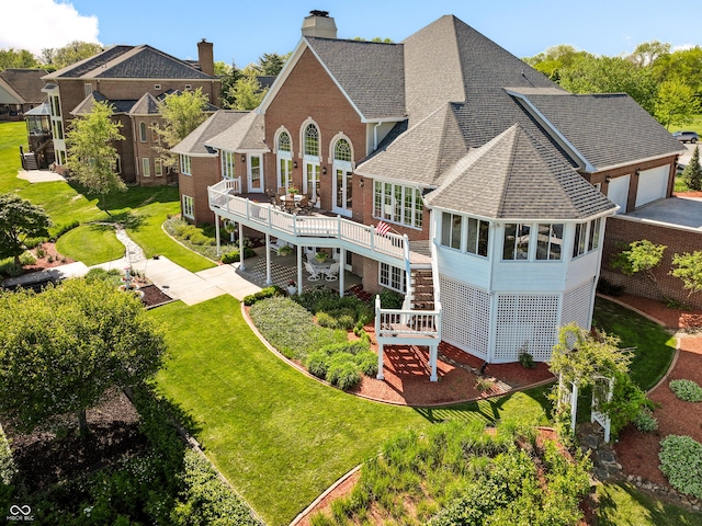 3107 Waterfront Cir, Anderson, IN 46012 - rear view of house featuring roof with shingles, a wooden deck, stairway, a lawn, and a chimney