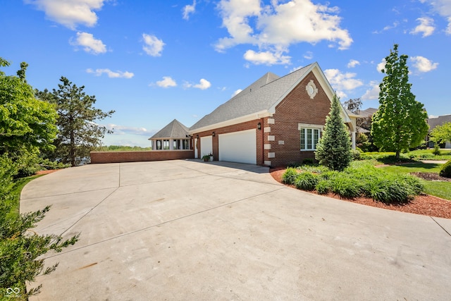 3107 Waterfront Cir, Anderson, IN 46012 - view of home's exterior featuring brick siding, driveway, and an attached garage