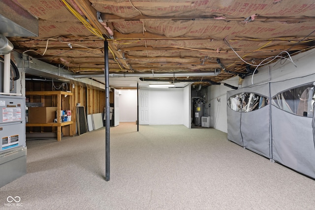 unfinished basement featuring carpet floors and electric water heater