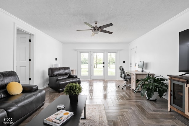 living area with ceiling fan, a desk, ornamental molding, french doors, and a textured ceiling