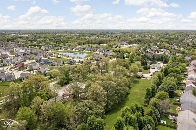 aerial view of property and surrounding area featuring nearby suburban area and a large body of water