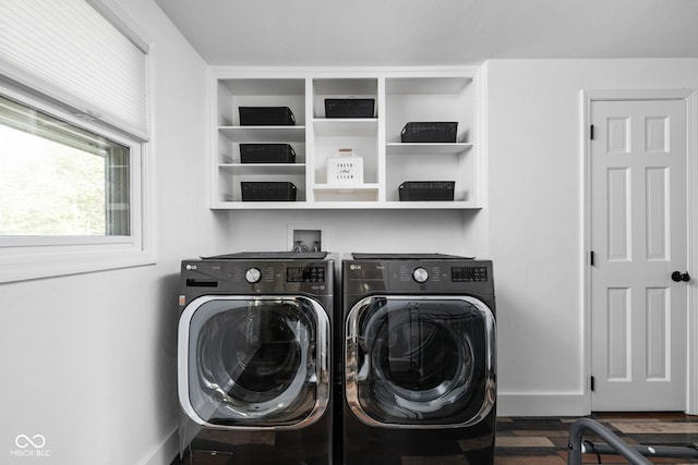 laundry room with washing machine and clothes dryer, wood finished floors, and baseboards