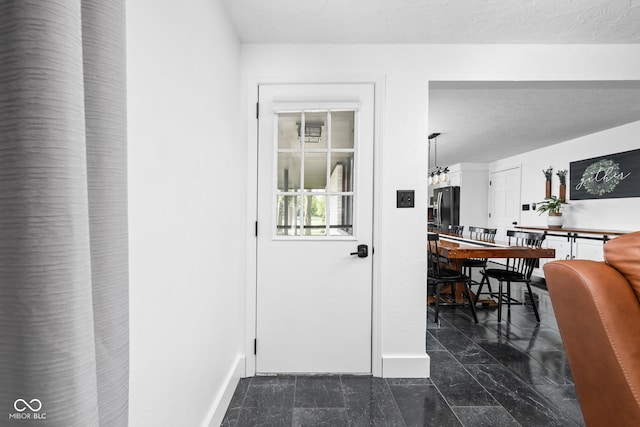 entryway featuring a textured ceiling