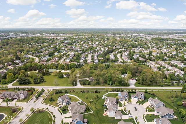 aerial view of property and surrounding area featuring nearby suburban area