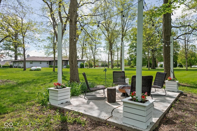 view of green lawn featuring a patio