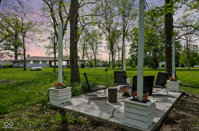 view of property's community with a patio area and a lawn
