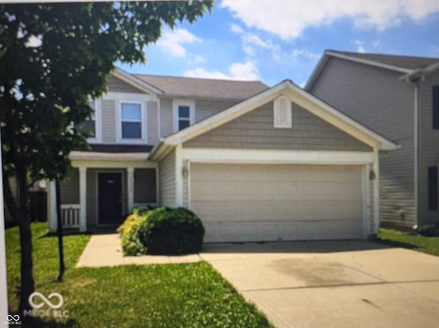 10425 Candy Apple Ln, Indianapolis, IN 46235 - view of front of home featuring an attached garage, driveway, and a front lawn