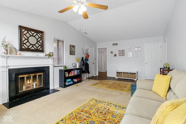 living room with lofted ceiling, carpet, ceiling fan, and a fireplace with flush hearth