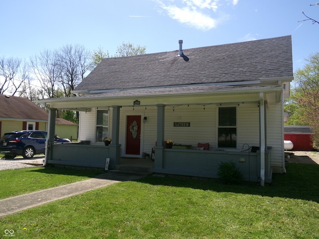 bungalow-style house with a porch, a front lawn, and a shingled roof