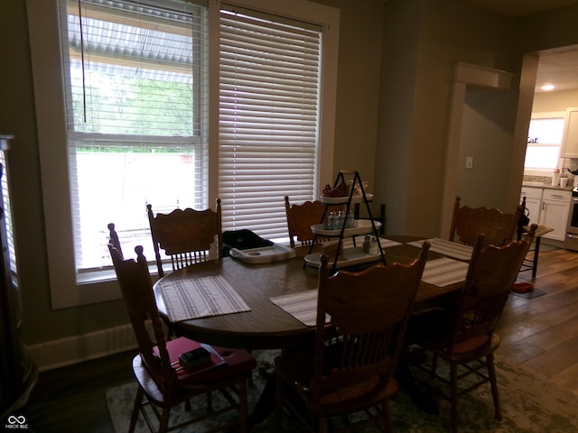 dining space with dark wood-style flooring