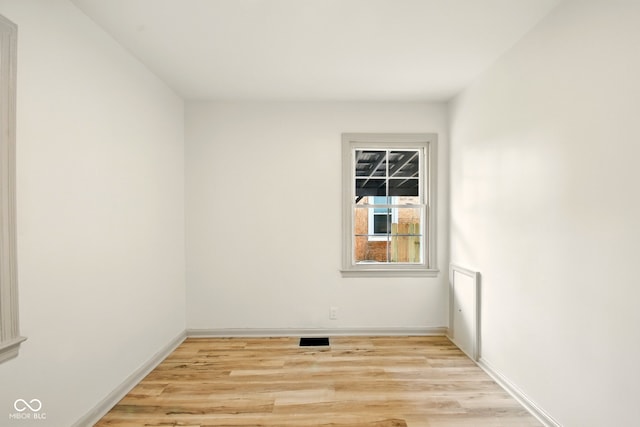 empty room featuring light wood-style floors and baseboards