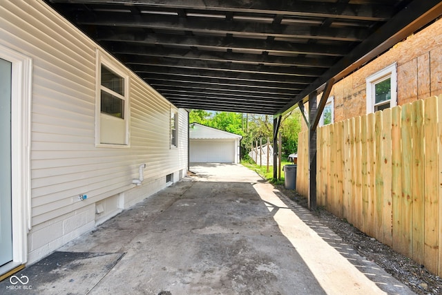 view of patio featuring fence and an attached carport