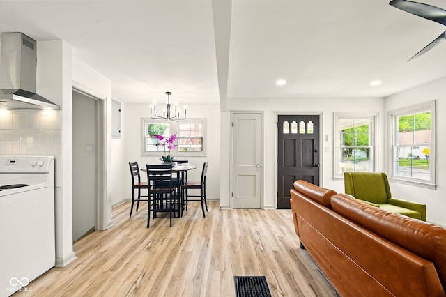 living room featuring light wood-type flooring, a chandelier, and recessed lighting