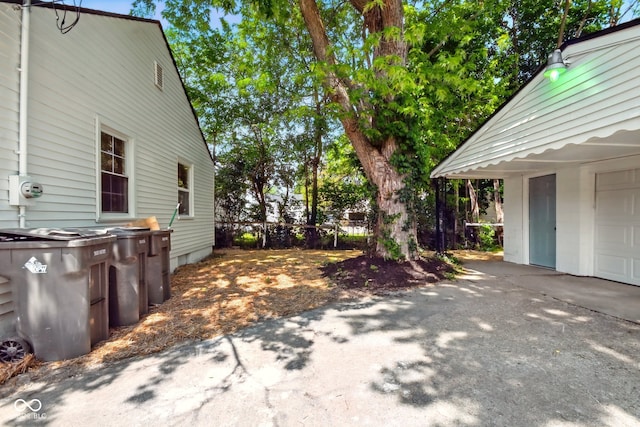view of property exterior with a garage and driveway