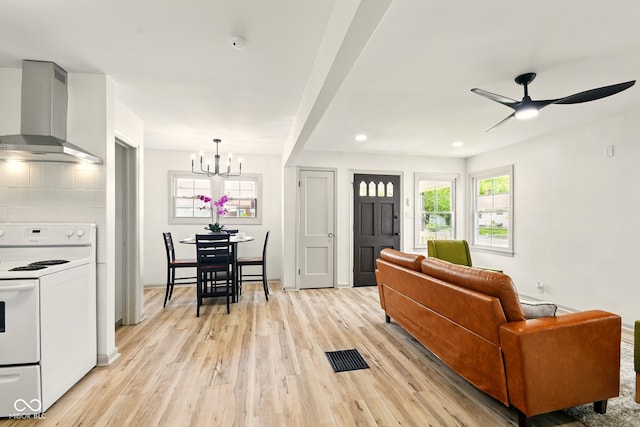 living area featuring light wood-type flooring, a chandelier, a ceiling fan, and recessed lighting