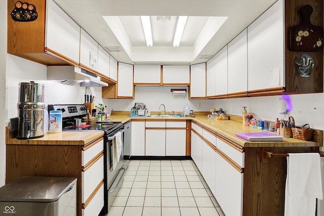 kitchen featuring stainless steel electric range oven, under cabinet range hood, a sink, white cabinetry, and light tile patterned floors
