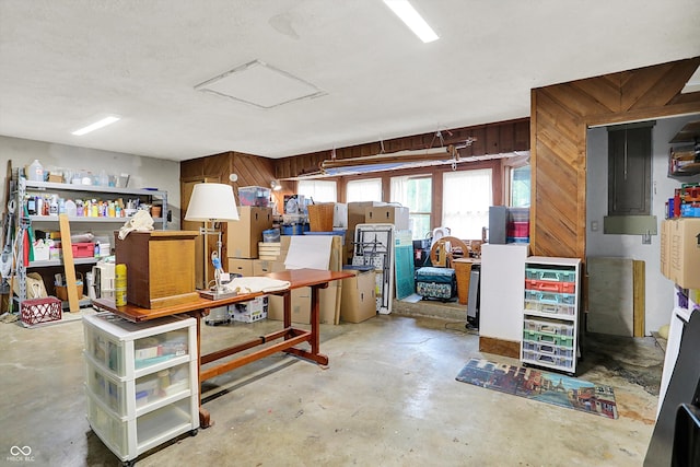 basement featuring wooden walls and a workshop area
