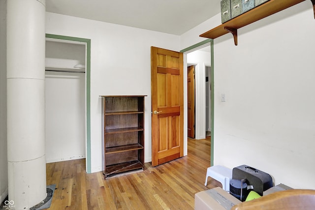 bedroom featuring wood finished floors and a closet