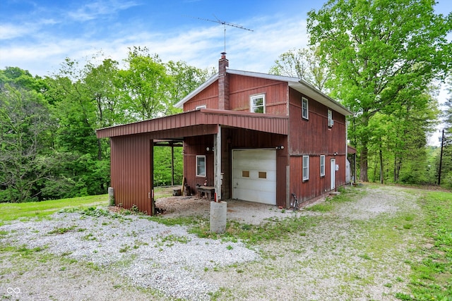 view of outbuilding featuring driveway and an outdoor structure