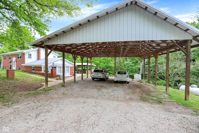 view of car parking featuring a detached carport and dirt driveway