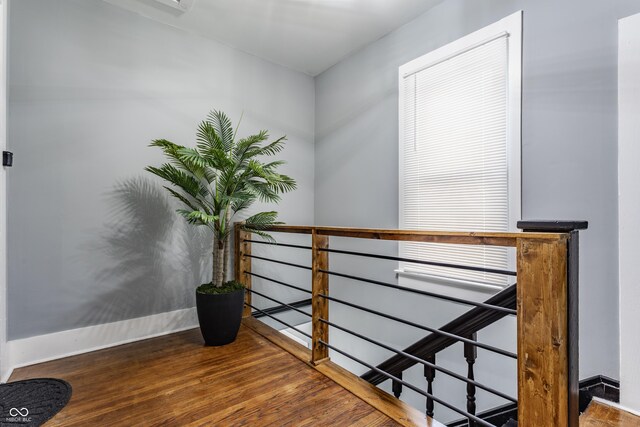 stairs with wood finished floors and baseboards