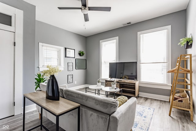living area featuring healthy amount of natural light and baseboards