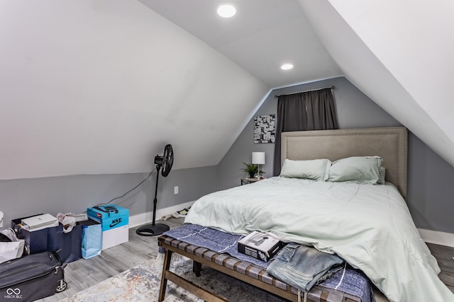 bedroom with wood finished floors, baseboards, lofted ceiling, and recessed lighting