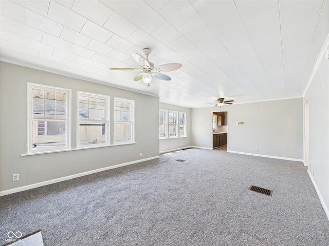 3631 Columbus Ave, Anderson, IN 46013 - unfurnished living room featuring a ceiling fan, carpet flooring, crown molding, and baseboards