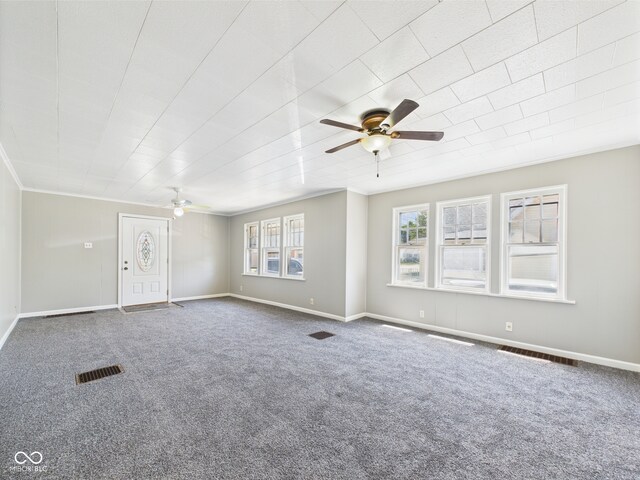 3631 Columbus Ave, Anderson, IN 46013 - unfurnished living room featuring ceiling fan, carpet floors, ornamental molding, and baseboards