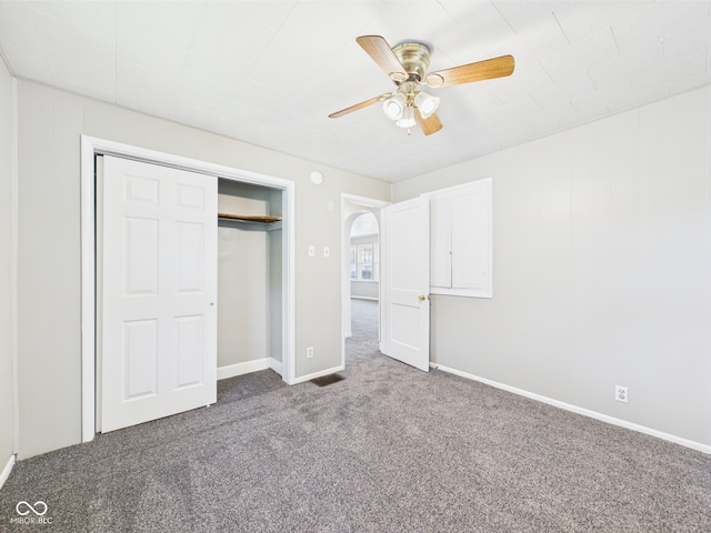 3631 Columbus Ave, Anderson, IN 46013 - unfurnished bedroom featuring carpet, a closet, baseboards, ceiling fan, and arched walkways